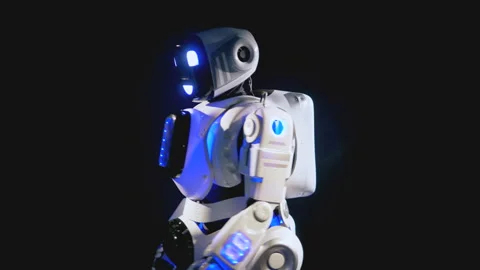 A robot stands stand half-way, then turns and greets. 4K. Stock Footage 88435079