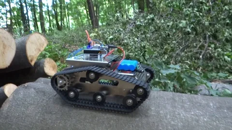 Robot Tank Driving In a Forest On a Tree Falls Stock Footage 114070230
