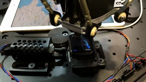 Robot for testing touch-screen devices in action on a smart watch Stock Footage 107191313