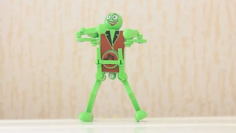 Robot toy dancing green mechanical clockwork toy dancing Stock Footage 242434857