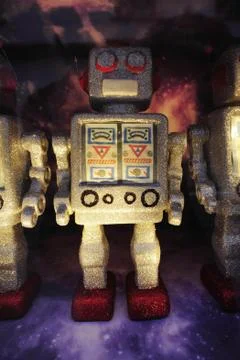 Robot toy figures on space background Stock Photos