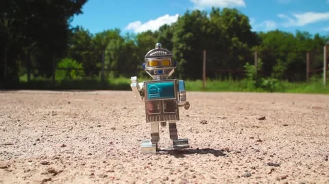 Robot Toy walking down the street Stock Footage