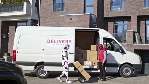 Robot with a trolley going to delivery van with parcel boxes to deliver them to Stock Footage 166173993