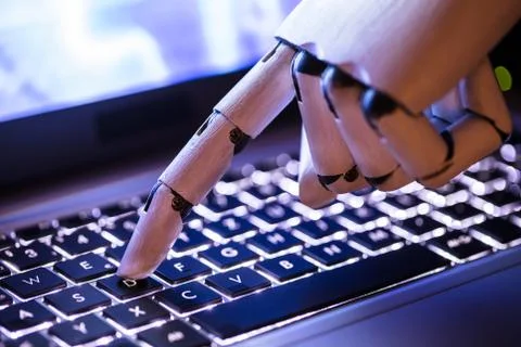Robot Typing On Laptop Stock Photos