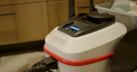 Robot Vacuum Charges at Its Docking Station in Living Room Stock Footage 340276095