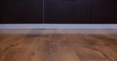 Robot vacuum cleaner carries empty plate of sweets from left to right Stock Footage 104960084