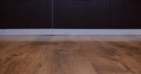 Robot vacuum cleaner carries empty plate of sweets from right to left Stock Footage 104960124