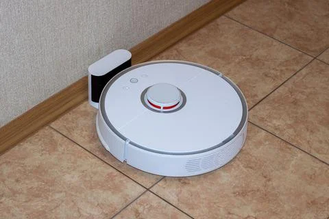 Robot vacuum cleaner on the charging dock after the finished cleaning Stock Photos