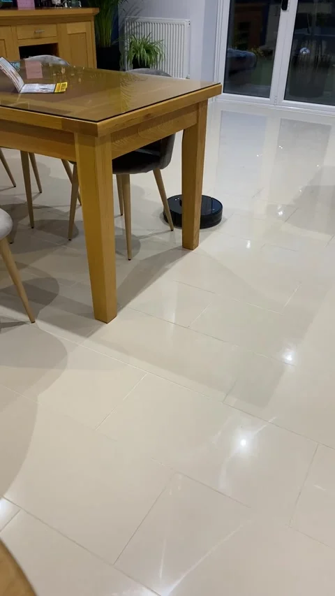 Robot Vacuum Cleaner Cleaning Tiled Floor in Modern Home Interior Stock Footage 346751206