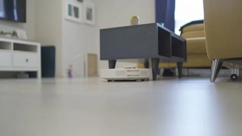 Robot vacuum cleaner cleans around the table, smart sensors Stock Footage 219484291
