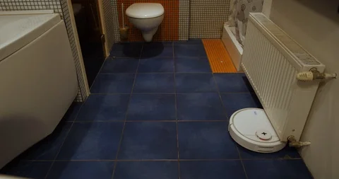 Robot vacuum cleaner cleans the bathroom timelapse Stock Footage 105188946