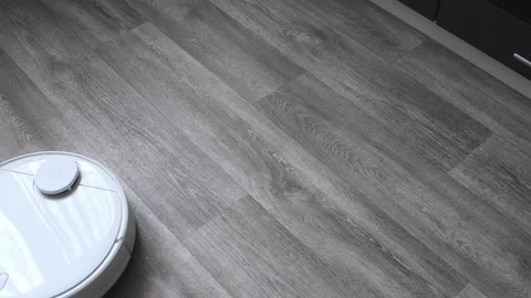 The robot vacuum cleaner cleans the carpet Video stock 166036033