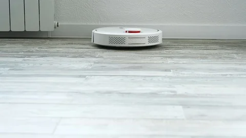 Robot vacuum cleaner cleans the floor Stock Footage 119372233