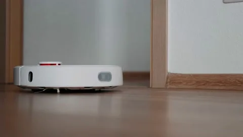Robot vacuum cleaner cleans the floor in the room. Smart Home. Housekeeping. Stock Footage 165723607