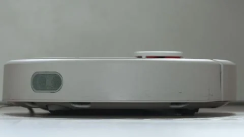 Robot vacuum cleaner cleans the floor from debris. Stock Footage 251022801
