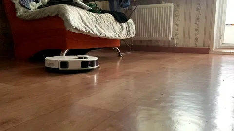 A robot vacuum cleaner cleans the floor in the apartment. Stock Footage 326739296