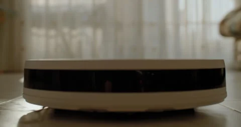 A robot vacuum cleaner cleans the house. Stock Footage 250751903