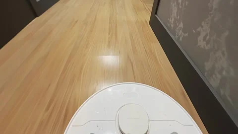 A robot vacuum cleaner cleans a room, shooting a first-person video. POV 库存影片 256896201