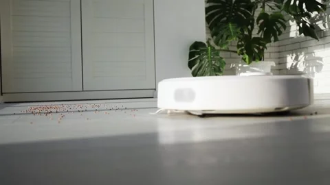The robot vacuum cleaner drives on the laminate floor Stock Footage 147451547