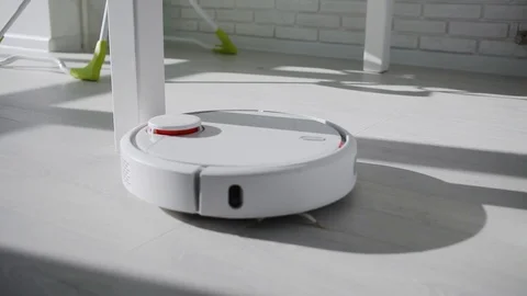 A robot vacuum cleaner Stock Footage 125440557