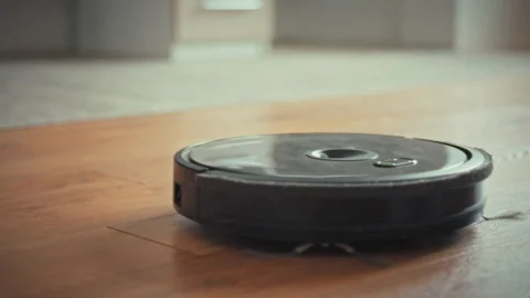 Robot vacuum cleaner glides across the floor its array of sensors and AI-dri Stock-Footage 331866215