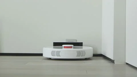 Robot vacuum cleaner goes to dock station on charging. Technology cleaning Stock Footage 164731033
