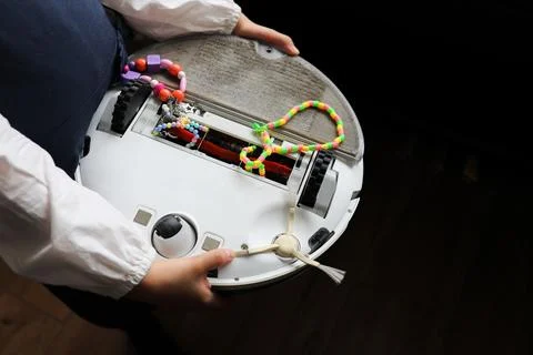 Robot vacuum cleaner in the hands of a problem Stock Photos
