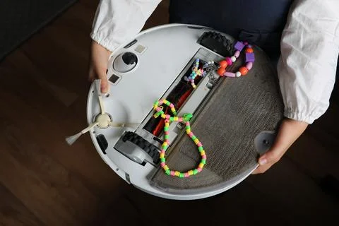Robot vacuum cleaner in the hands of a problem Stock Photos