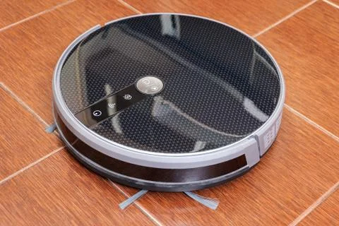 Robot vacuum cleaner in the kitchen Stock Photos