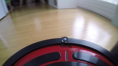 Robot vacuum cleaner moving on the floor. Camera mounted directly on the Sweeper Vidéo 82347424
