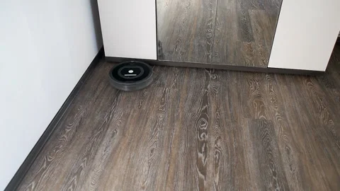 Robot vacuum cleaner is moving on the floor Stock Footage 107918279