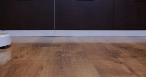 Robot vacuum cleaner passes from the left to the right close-up Stock Footage 104960315