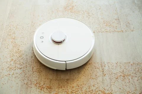 Robot vacuum cleaner performs automatic cleaning of the apartment at a certain Stock Photos