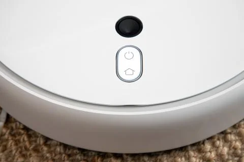 Robot vacuum cleaner performs automatic cleaning of the apartment at a certain Stock Photos