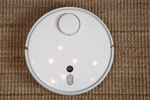 Robot vacuum cleaner performs automatic cleaning of the apartment at a certai Stock Photos