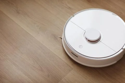 Robot vacuum cleaner performs automatic cleaning of the apartment at a certai Stock Photos