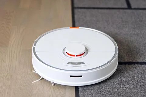 Robot vacuum cleaner performs automatic cleaning of the apartment with carpet Stock Photos