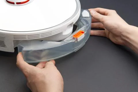 Robot vacuum cleaner replacing a container with water. Robot vacuum cleaner i Stock Photos