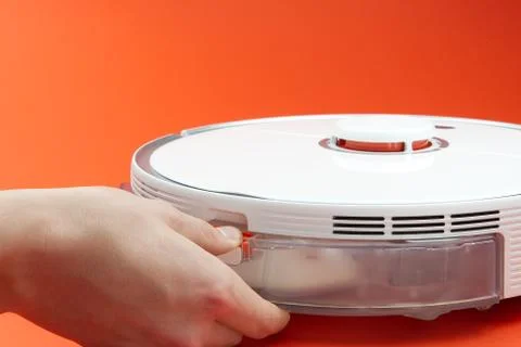 Robot vacuum cleaner replacing a container with water. Robot vacuum cleaner i Stock Photos