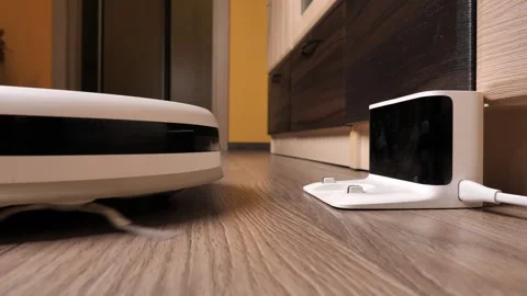 Robot vacuum cleaner stops at its station. the robot vacuum cleaner has fin.. Video stock 254610541