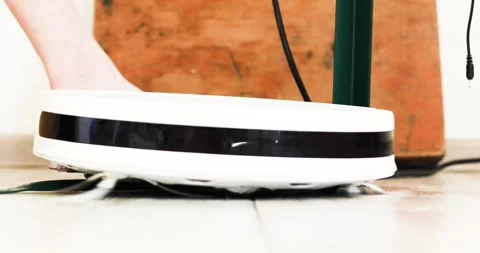 Robot vacuum cleaner stuck near the leg of a folding table while cleaning th 스톡 동영상 307828222