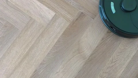Robot vacuum cleaner vacuuming the floor in the bedroom Stock Footage 302373648