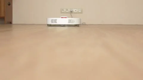 Robot vacuum cleaner washes the floor in the living room, it moves from the Video stock 270368251
