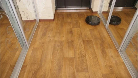 Robot Vacuum Cleaner at Work. Vacuuming Laminate, motion in the Frame. Video stock 151387356