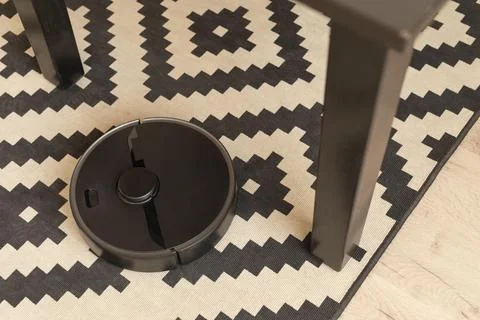 Robot vacuum doing its work house Stock Photos