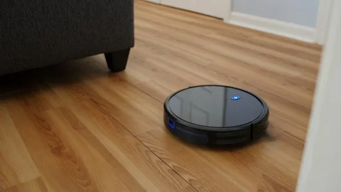Robot Vacuum Driving Down Hall Into Living Room Vídeo Stock 114038121