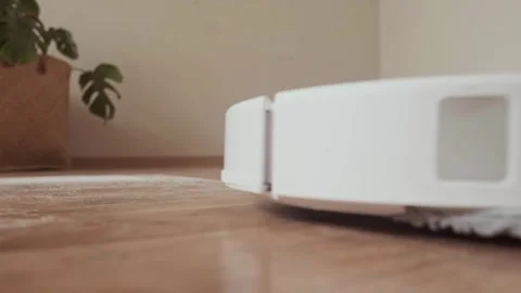 Robot vacuum saves time and effort for homeowners making daily cleaning easy Stock Footage 314641314
