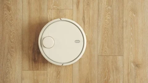 Robot vacuum sweeps and sucks the trash and dust in Stock Footage 243100503