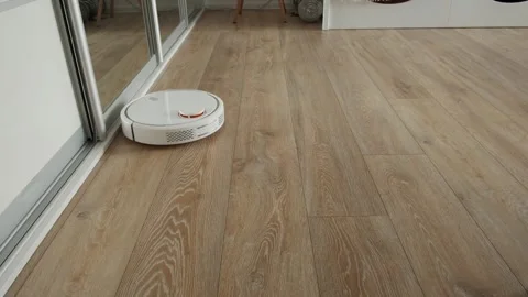 Robot vacuum sweeps and sucks the trash and dust in Stock Footage 250194927