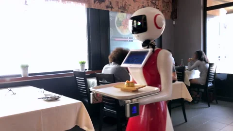 Robot waiter or waitress serves food at restaurant. Future concept of worker Stock Footage